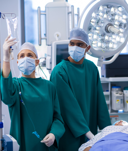 Specialist doctors in operating room checking drip bag